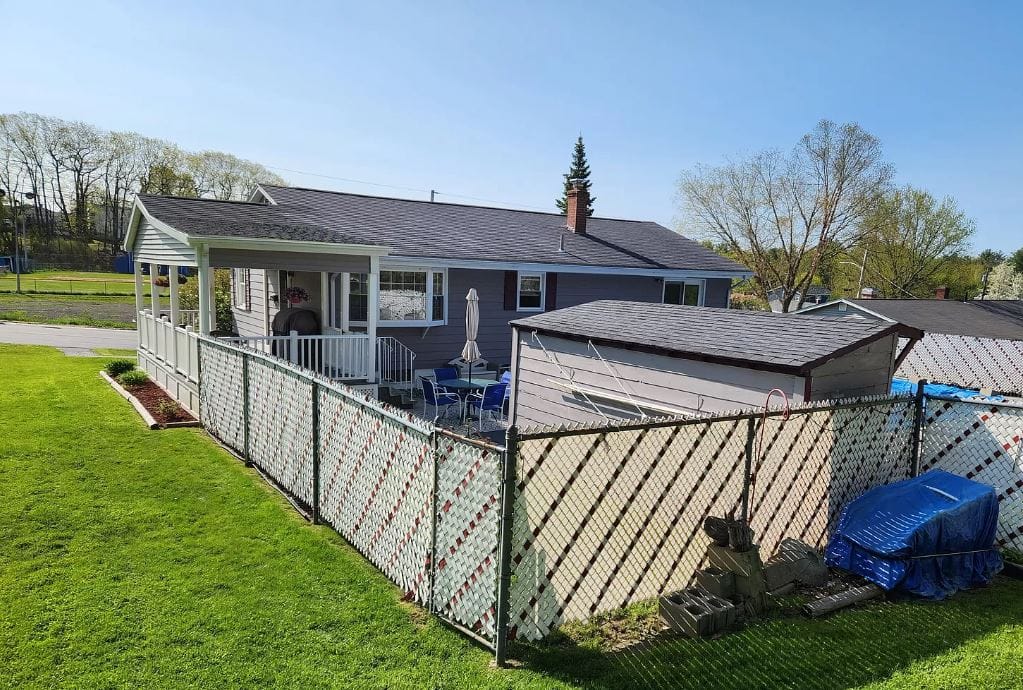 Exterior view of a house with a fence and garden