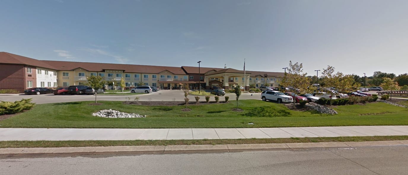 Exterior view of Meadow Brook Senior Living with landscaped gardens