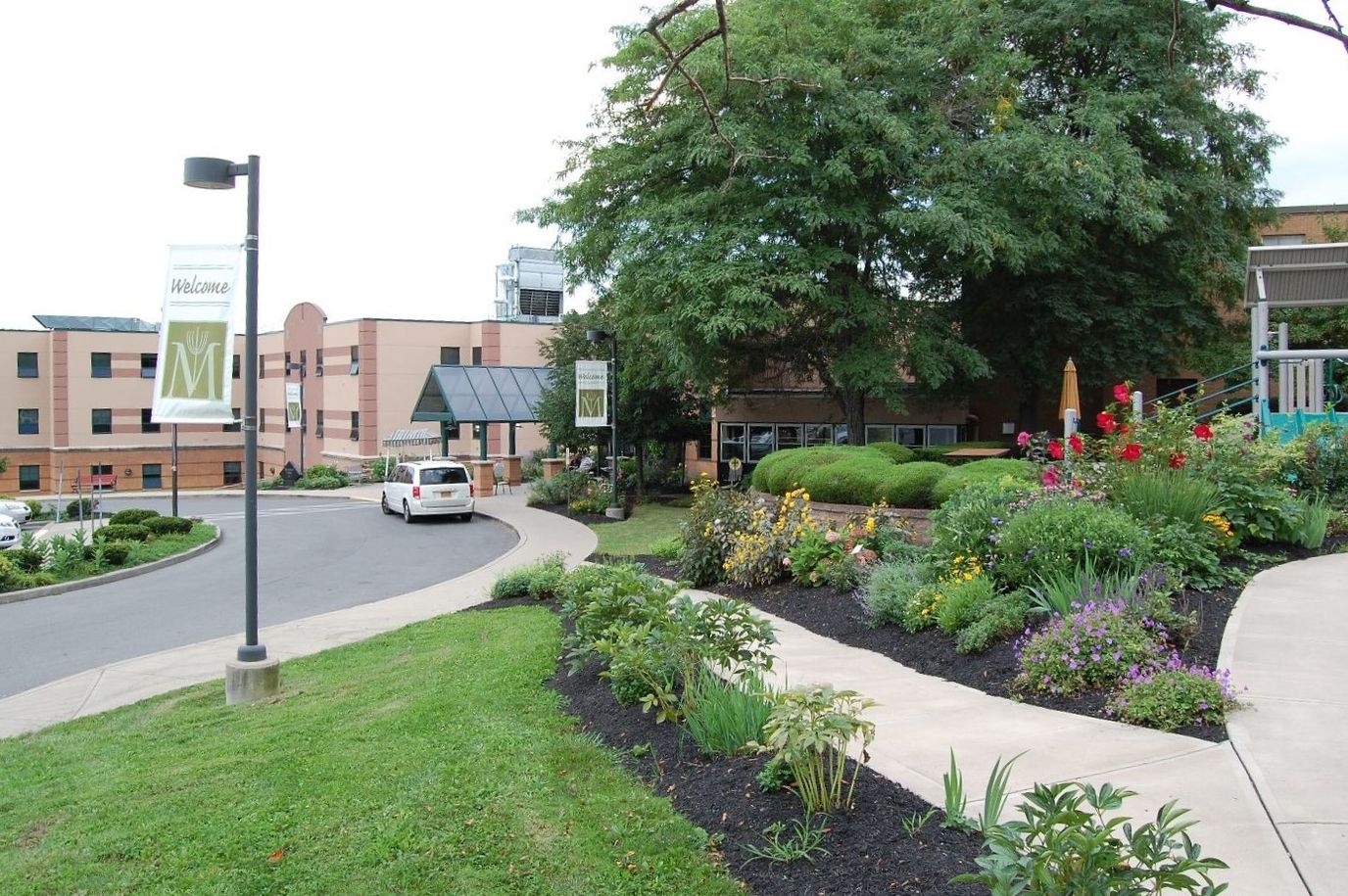 Entrance path with gardens and facility signage