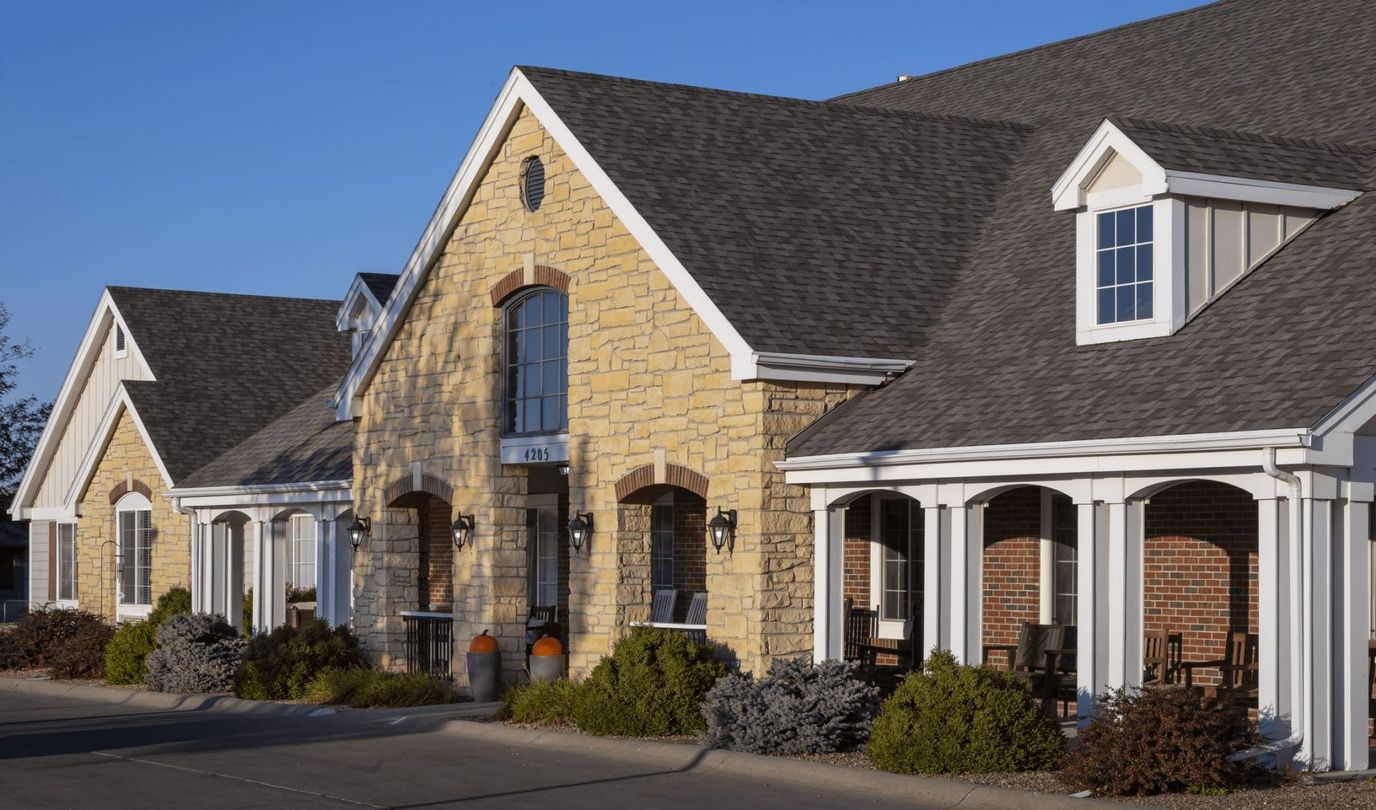 Exterior view of a senior living facility with landscaped surroundings