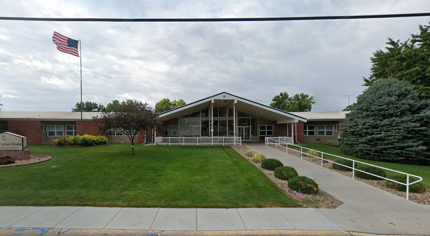 Exterior view of Mount Carmel Home with landscaped grounds