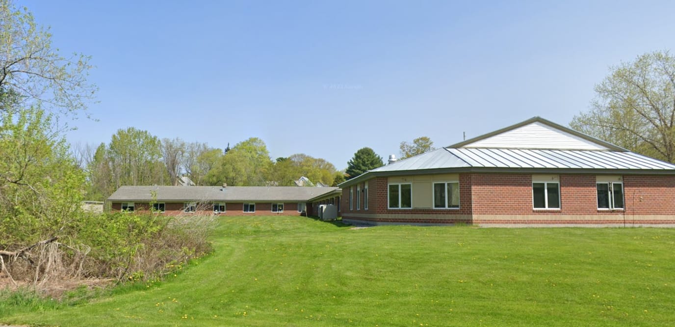 Exterior view of Oak Grove Center with grassy area