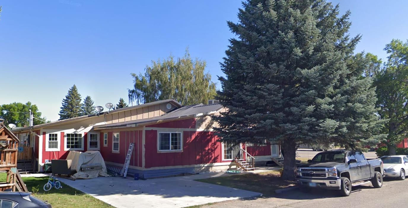 Exterior view of the assisted living facility with trees