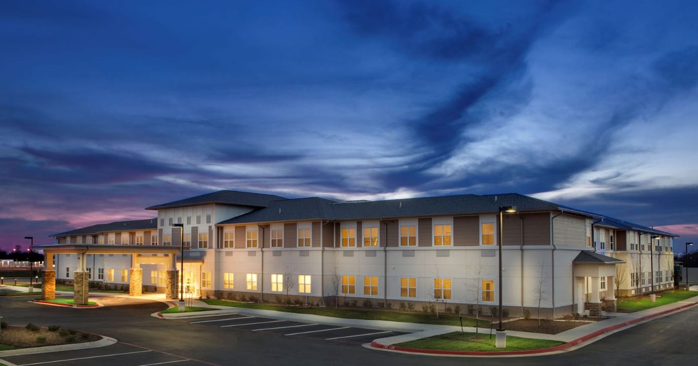 Exterior view of Prairie House Assisted Living at dusk