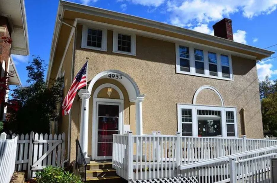 Exterior of Rakhma Peace Home with American flag