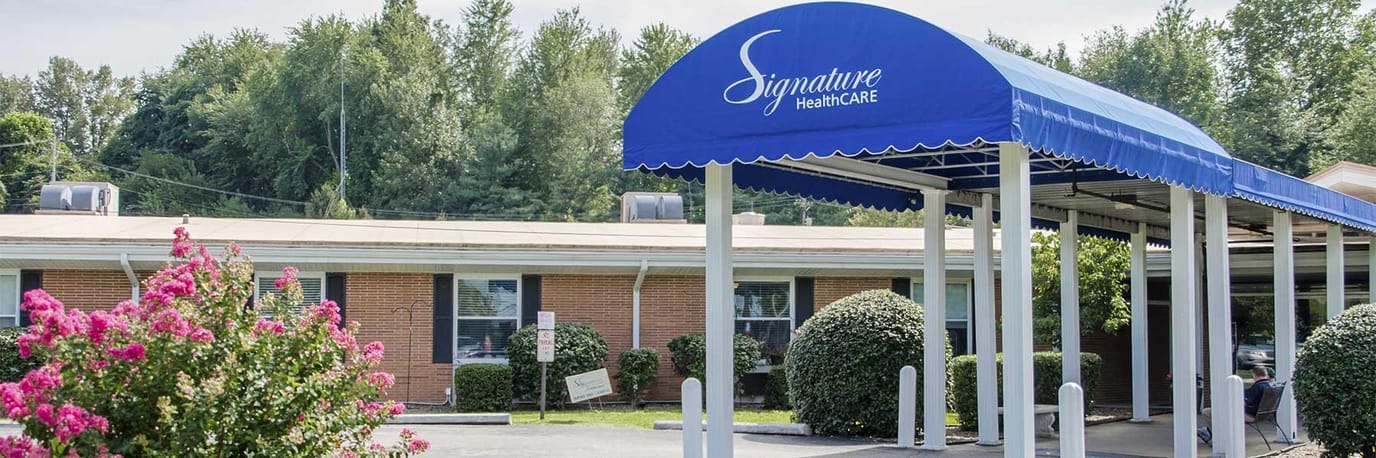 Building entrance with awning and flowers