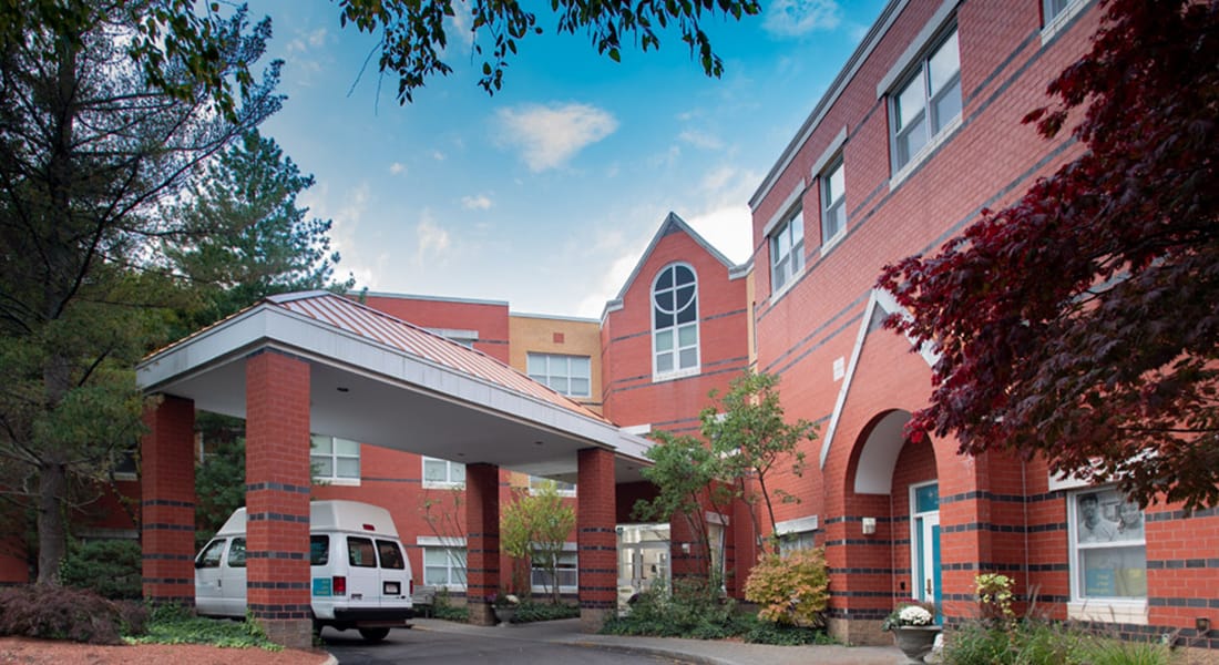 Entrance of Spaulding Nursing and Therapy Center with a vehicle