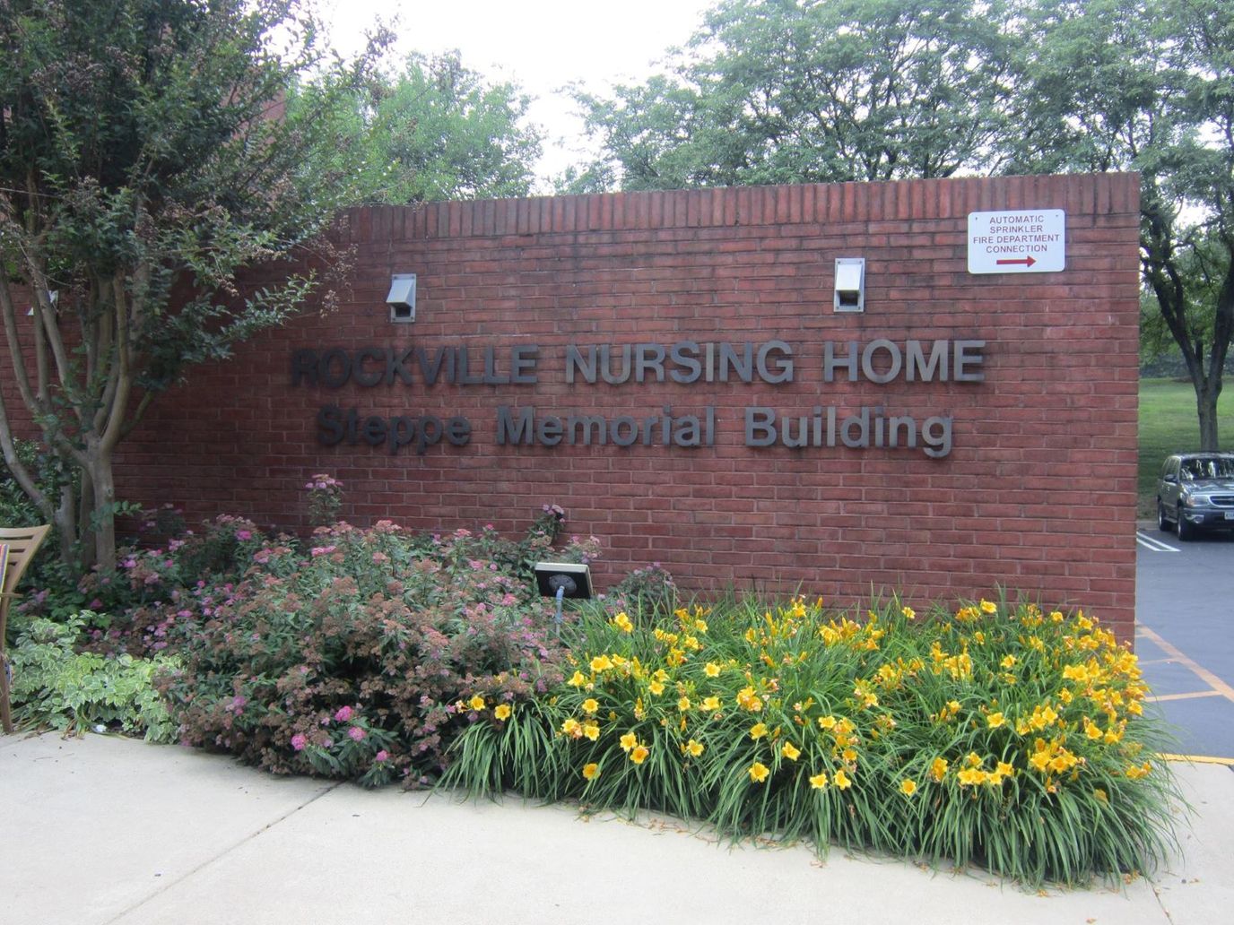 Exterior view of Rockville Nursing Home with flowers