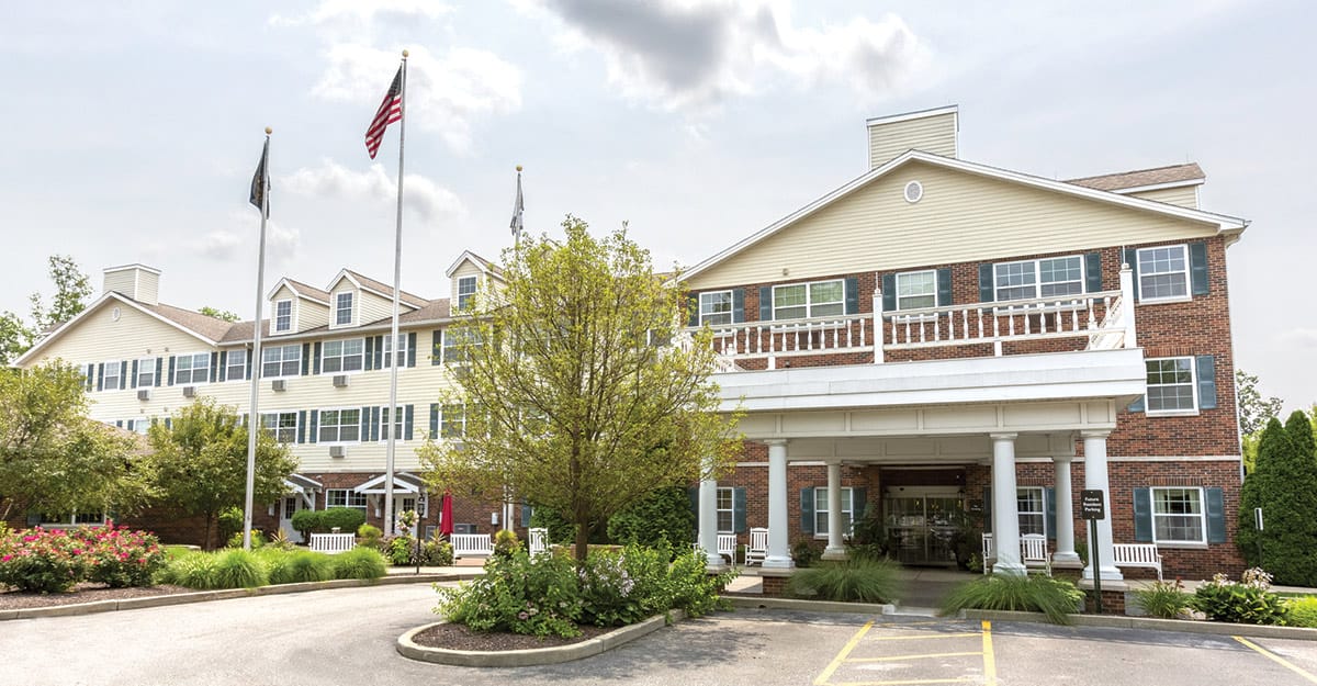 Exterior view of StoryPoint Granger with flags and landscaping
