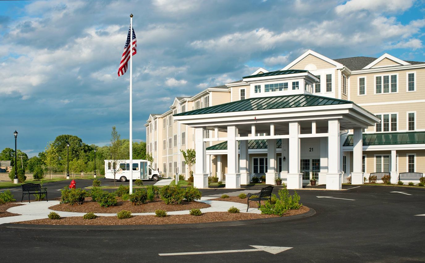 Exterior view of assisted living facility with flag
