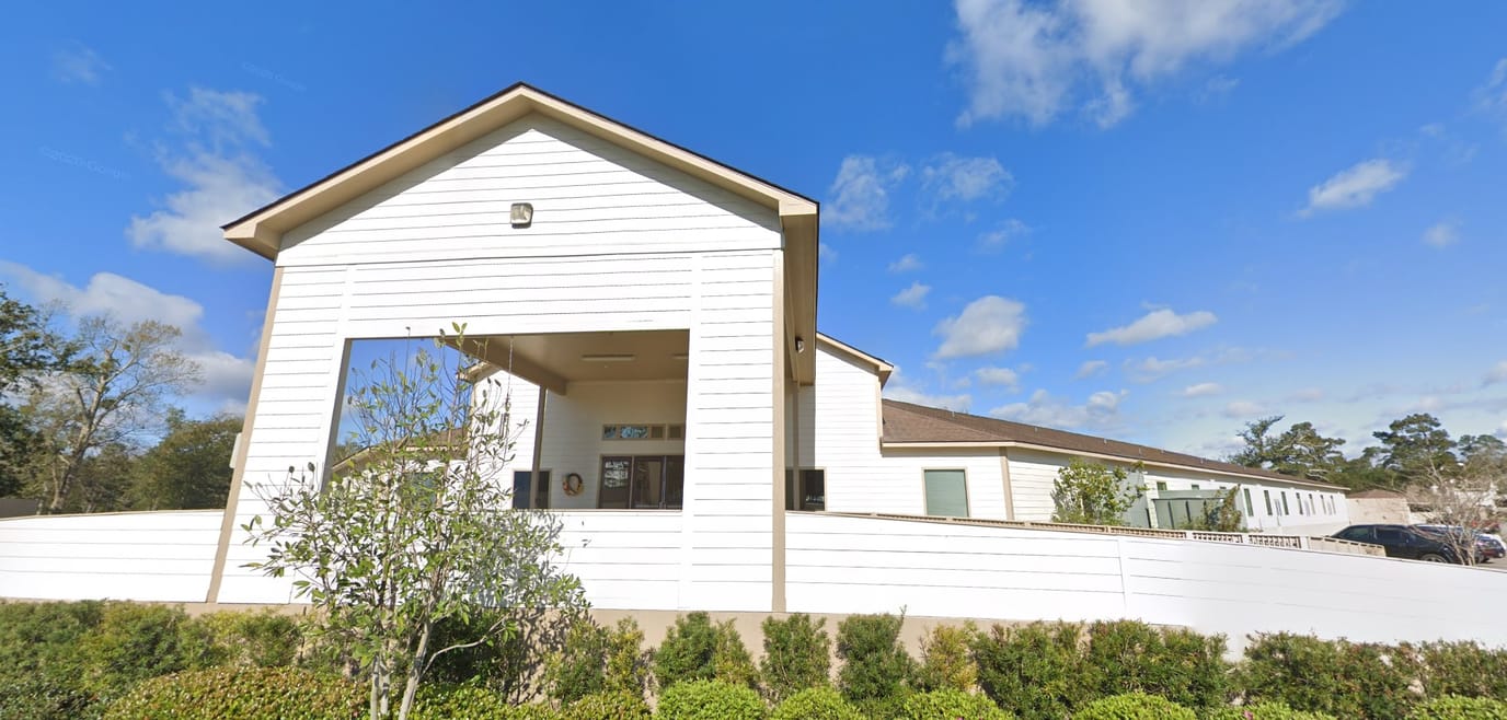Exterior view of a senior living facility with landscaping