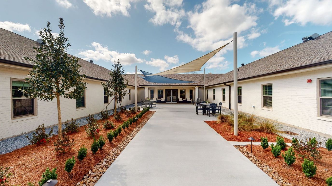 Outdoor courtyard area with shaded seating and landscaping