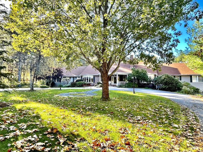 Exterior view of a nursing home surrounded by trees