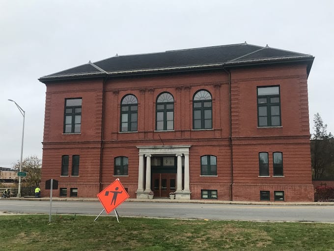 Exterior view of a historic building with construction sign