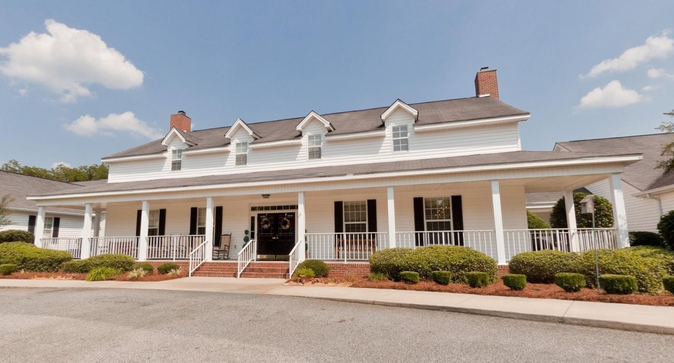 Exterior view of a senior living facility with a porch