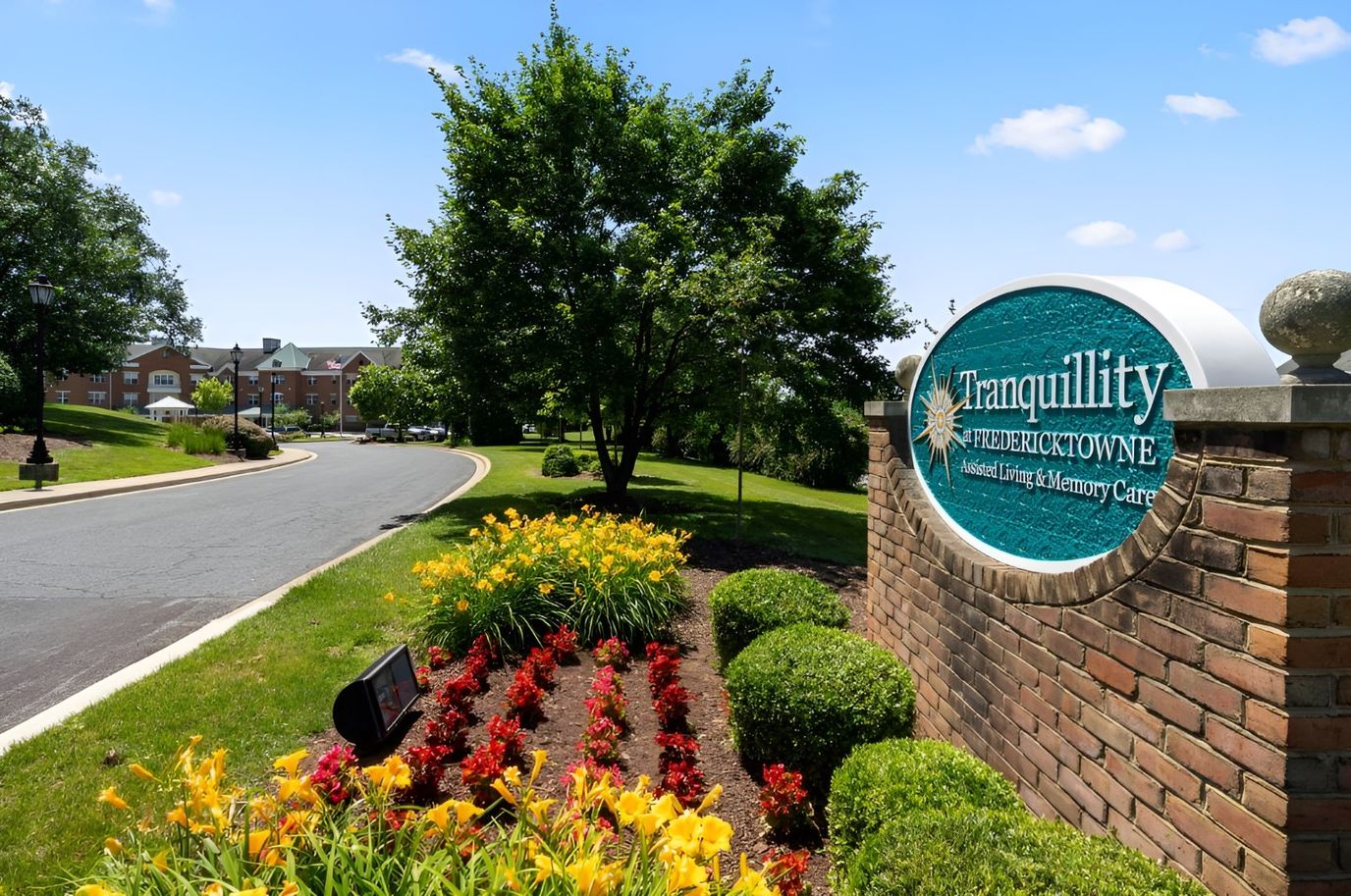Entrance sign of Tranquillity at Fredericktowne with landscaped flowers