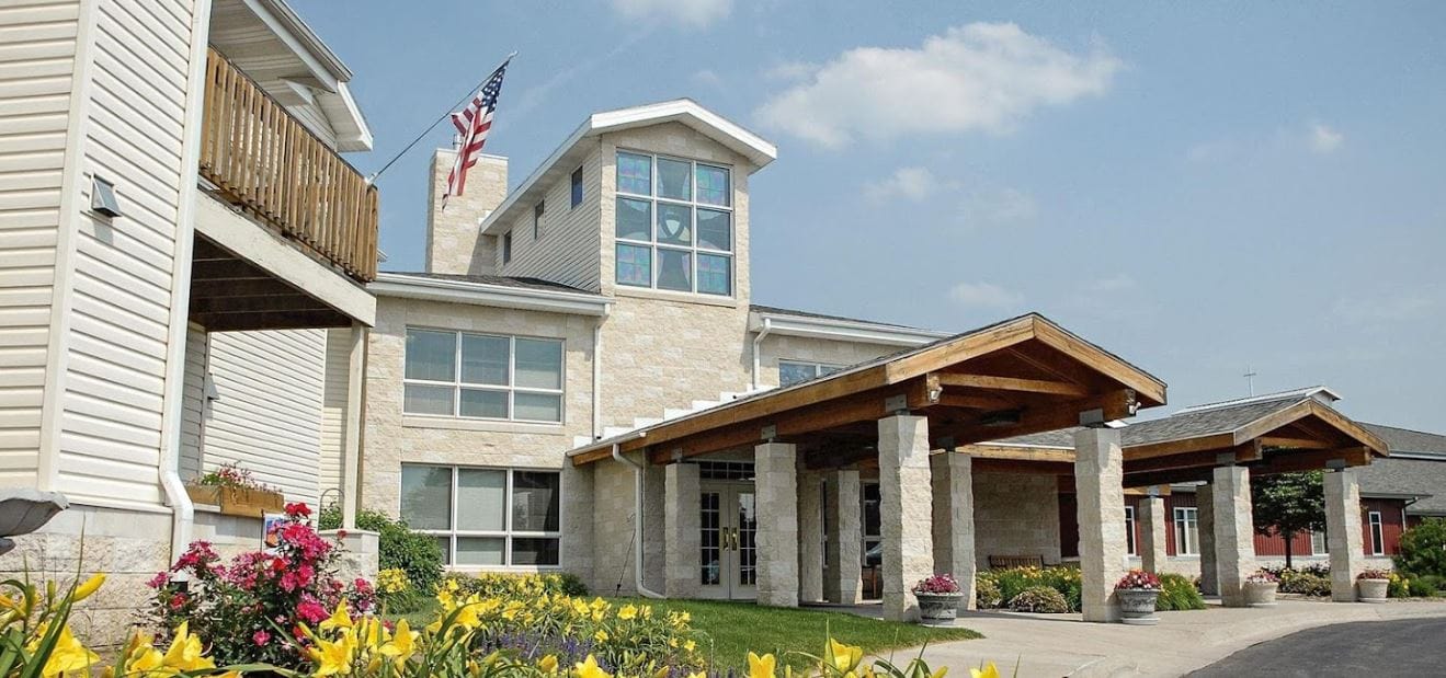 Exterior view of Trinity Village with flowers