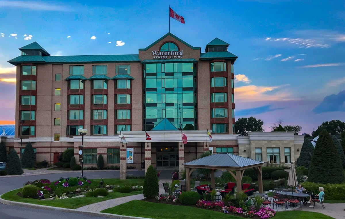 Exterior view of Waterford Senior Living with gardens