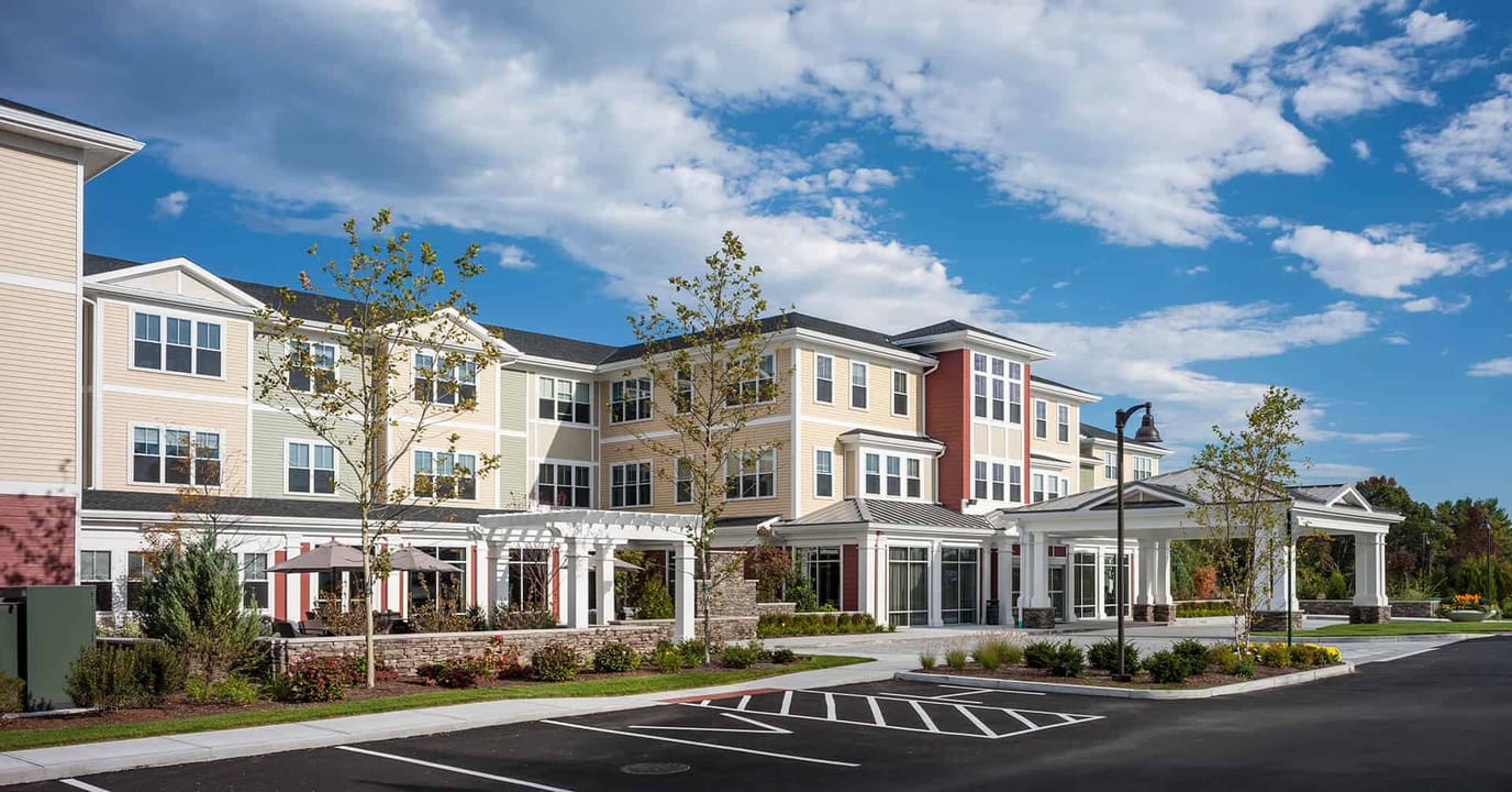 Exterior view of a senior living facility under sunny skies