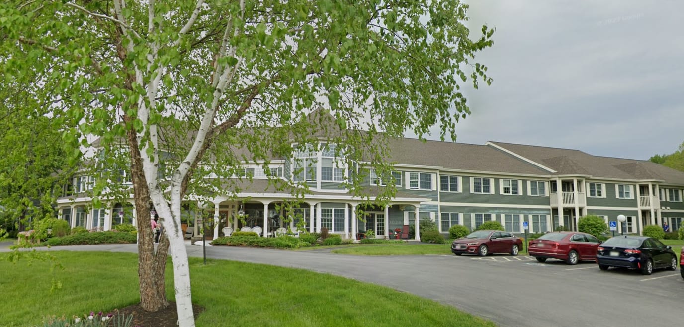 Exterior view of Woodlands Senior Living facility with landscaping