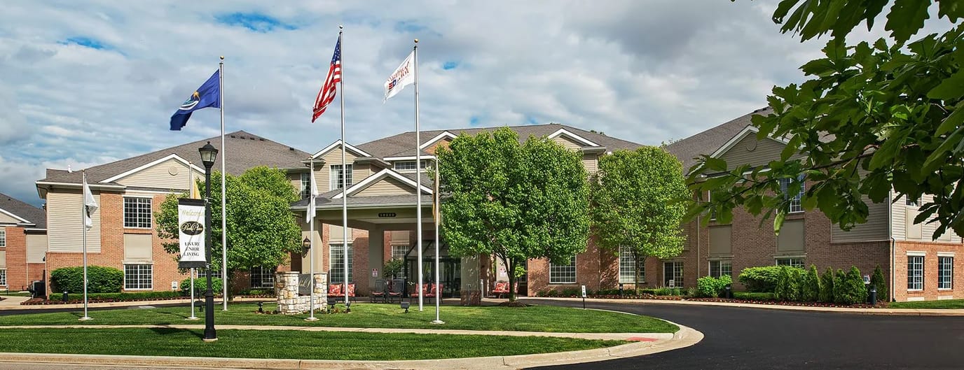 Exterior view of Park Place facility with flags and landscaping