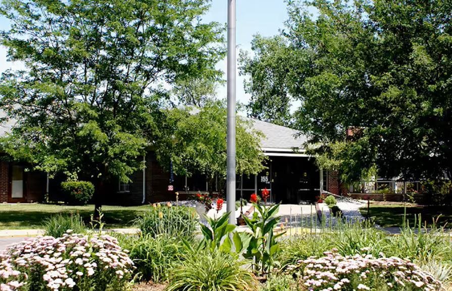 Exterior view of a senior living facility with flowers