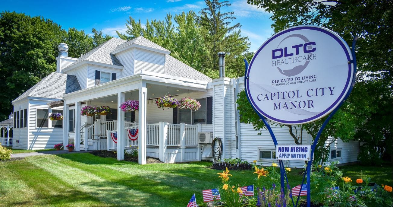 Exterior view of Capitol City Manor with health care sign