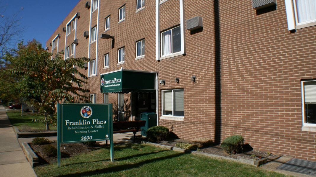 Exterior view of Franklin Plaza nursing center with signage