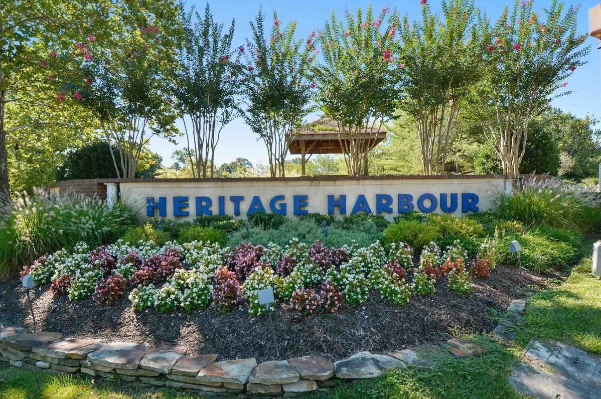 Heritage Harbour, independent living in Annapolis, MD — Heritage Harbour sign surrounded by colorful flower beds