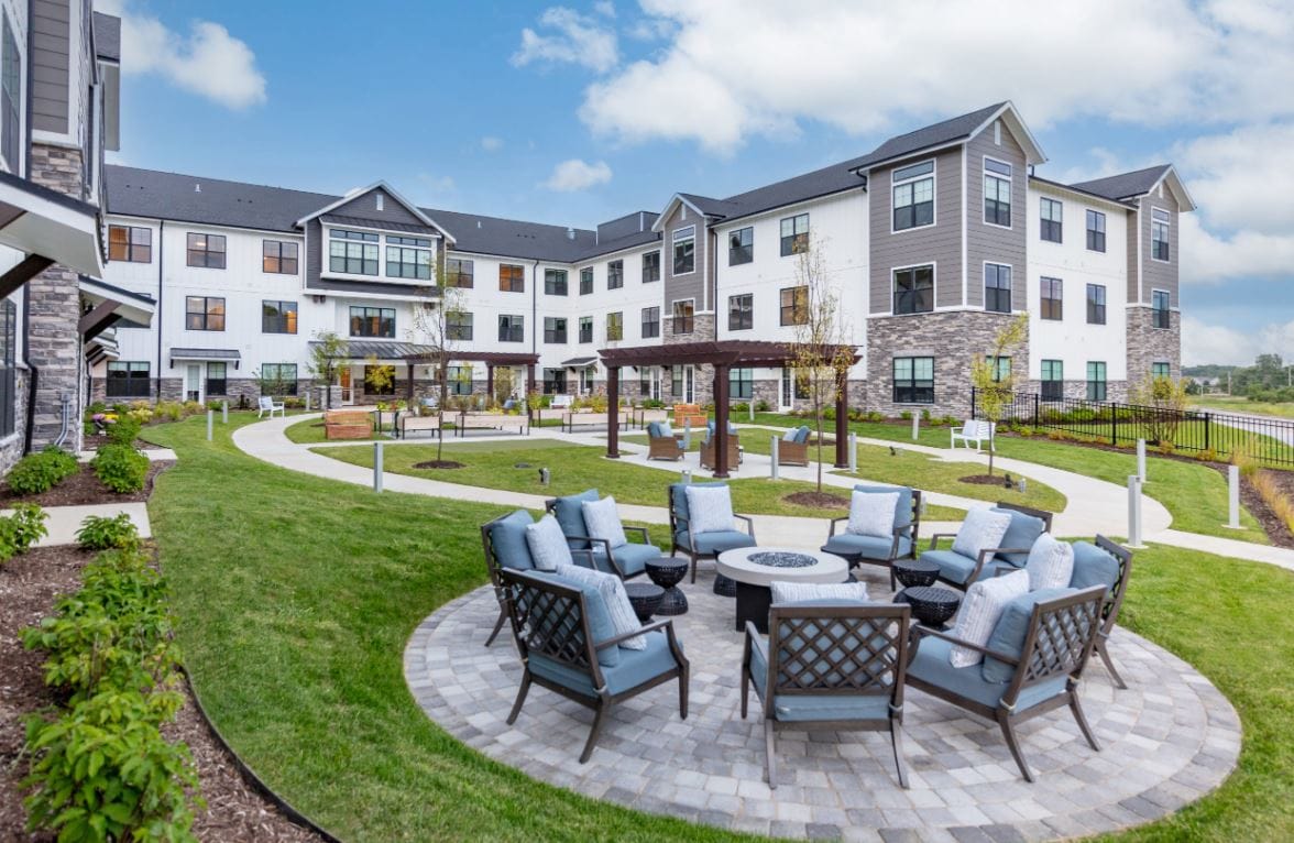 Outdoor area with seating and pathways at a senior living facility