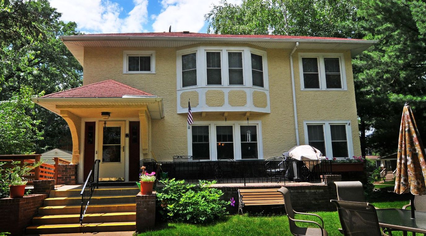Exterior view of a yellow multi-story residential building