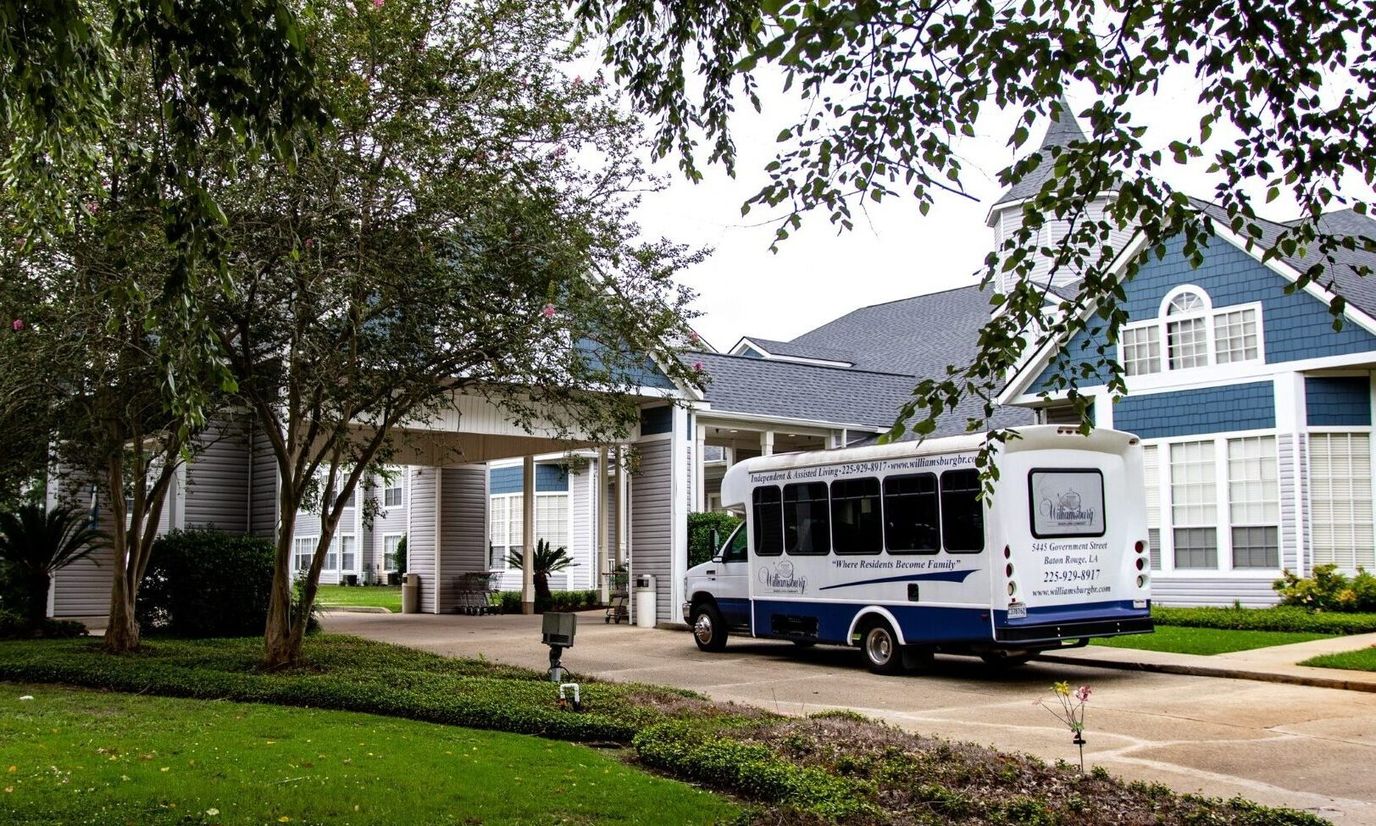 Exterior view of the senior living facility with a transport vehicle