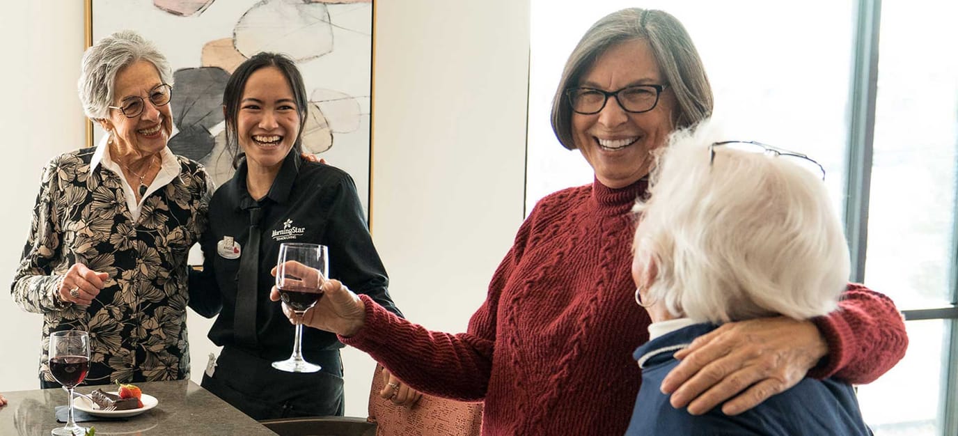 Residents and staff enjoying wine and conversation