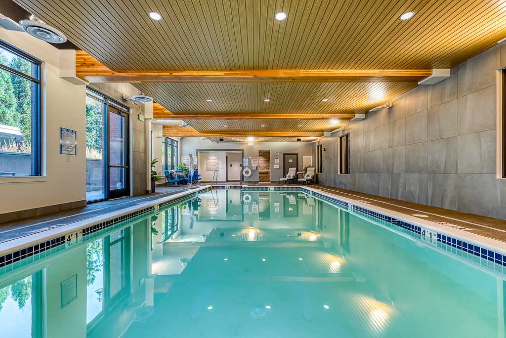 Indoor pool area with natural wood ceiling