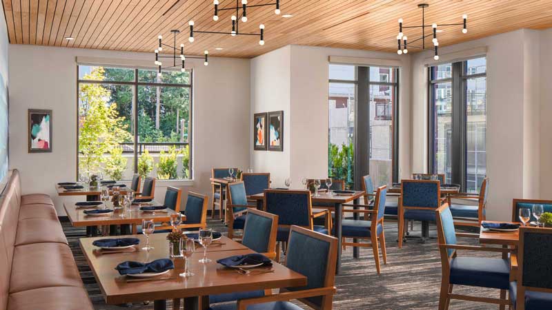 Bright dining room with tables set for meals