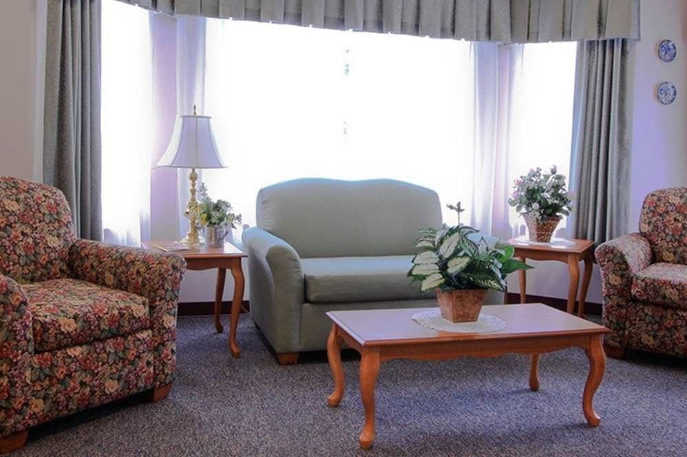 Cozy common area with floral sofas and natural light