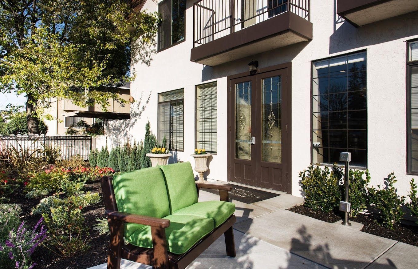 Entrance of a senior living facility with outdoor seating