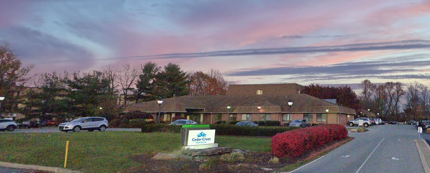 Exterior view of Cedar Crest Post Acute with sunset sky