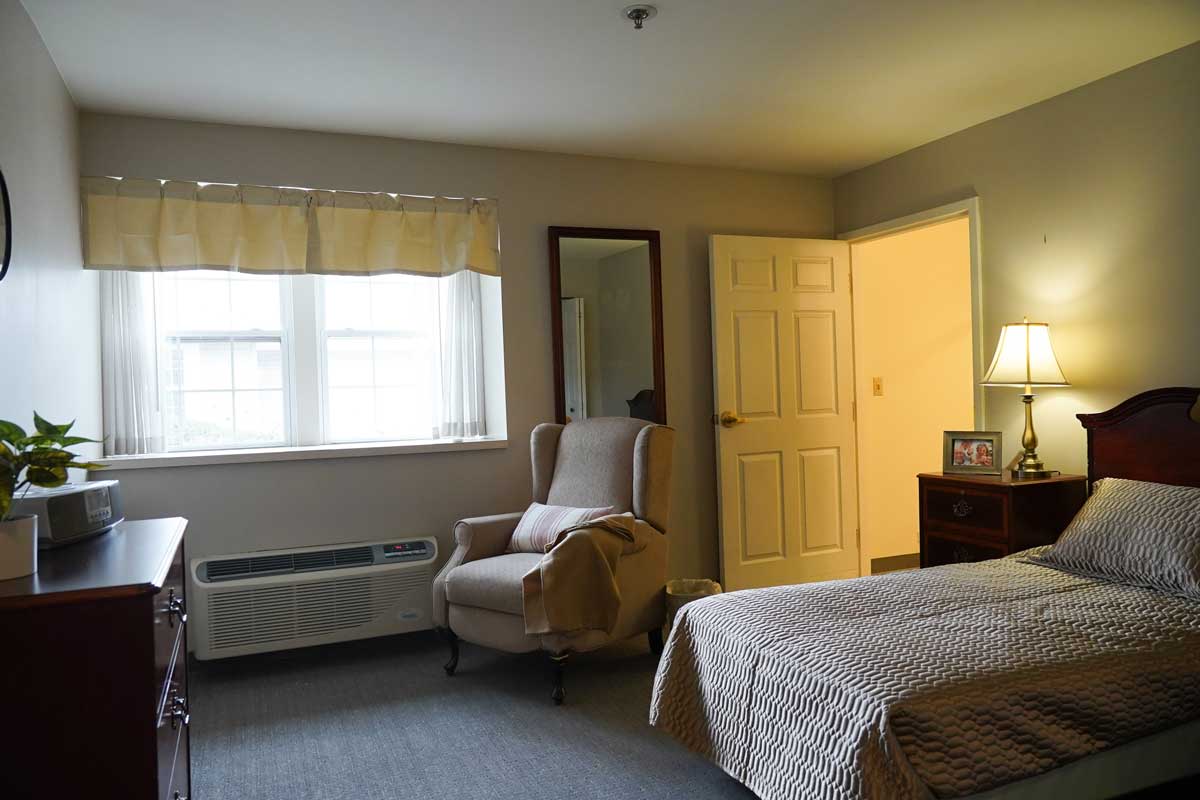 Cozy resident room with a bed and chair