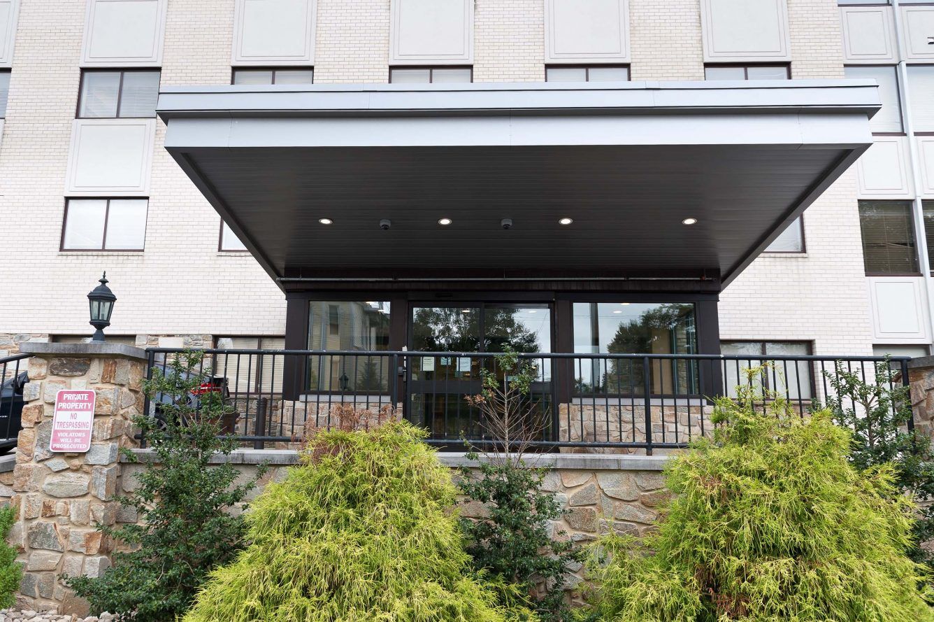 Front entrance of a senior living facility with landscaping