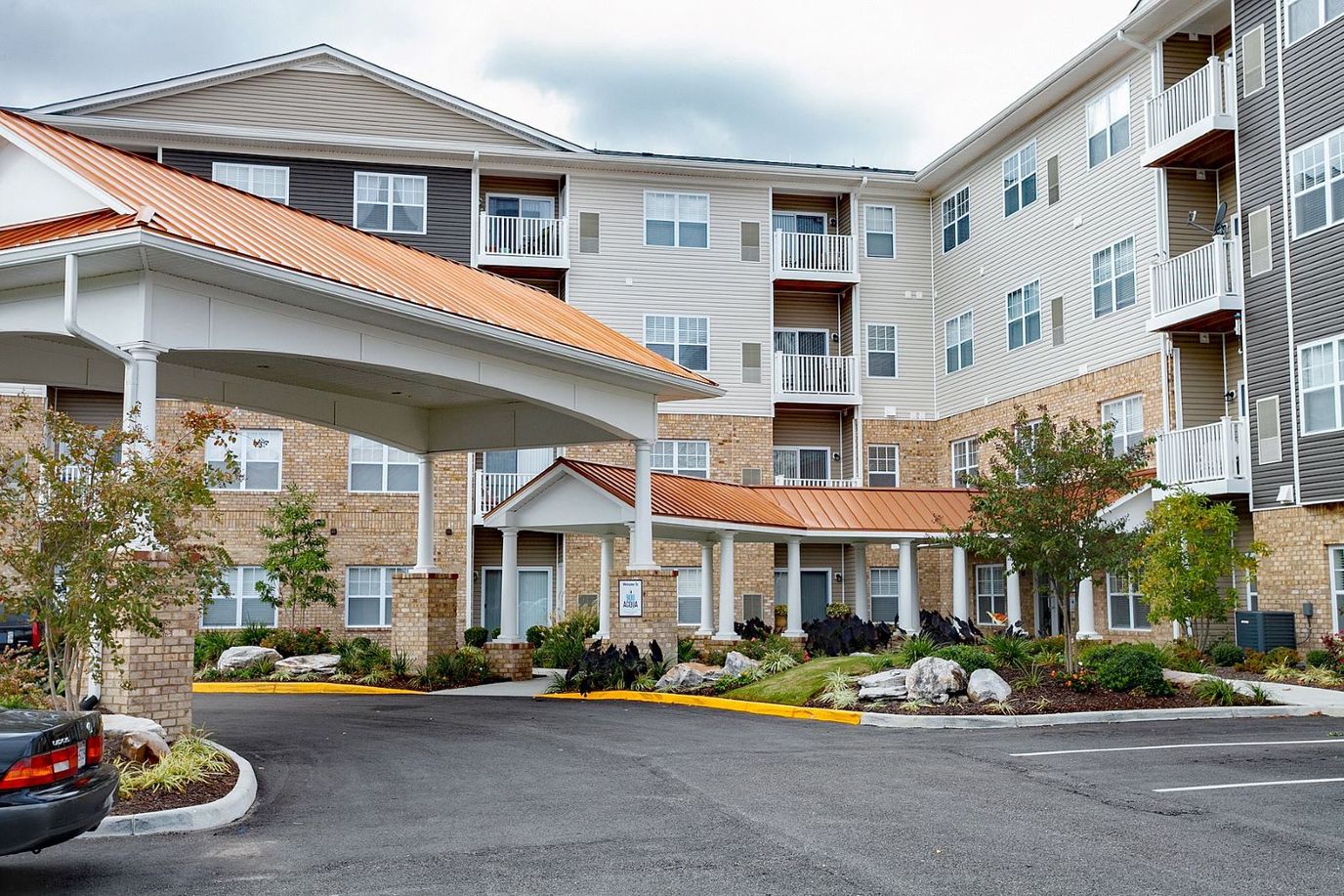 Front entrance of a senior living facility with landscaped area