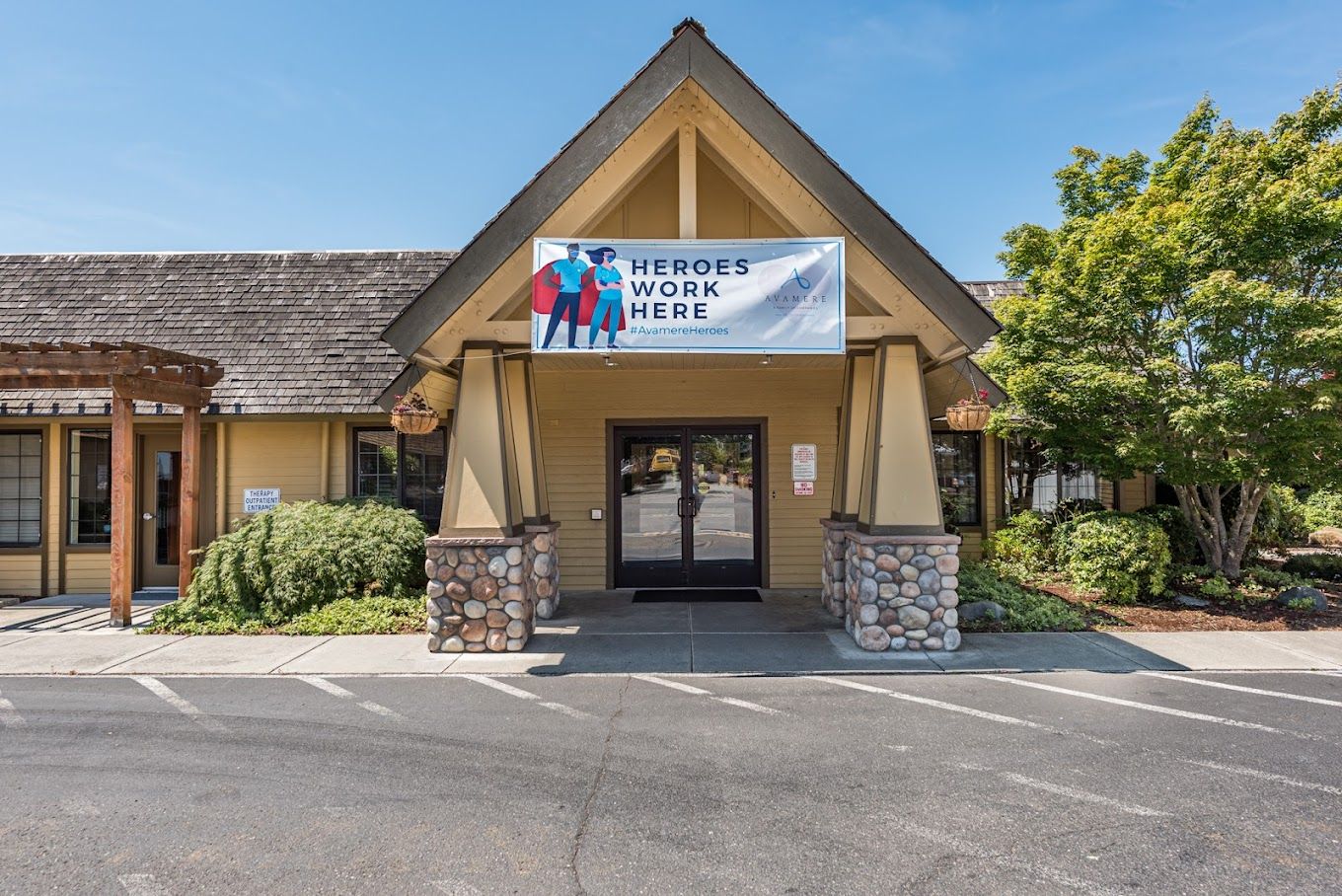 Front entrance of a senior living facility with a welcoming banner
