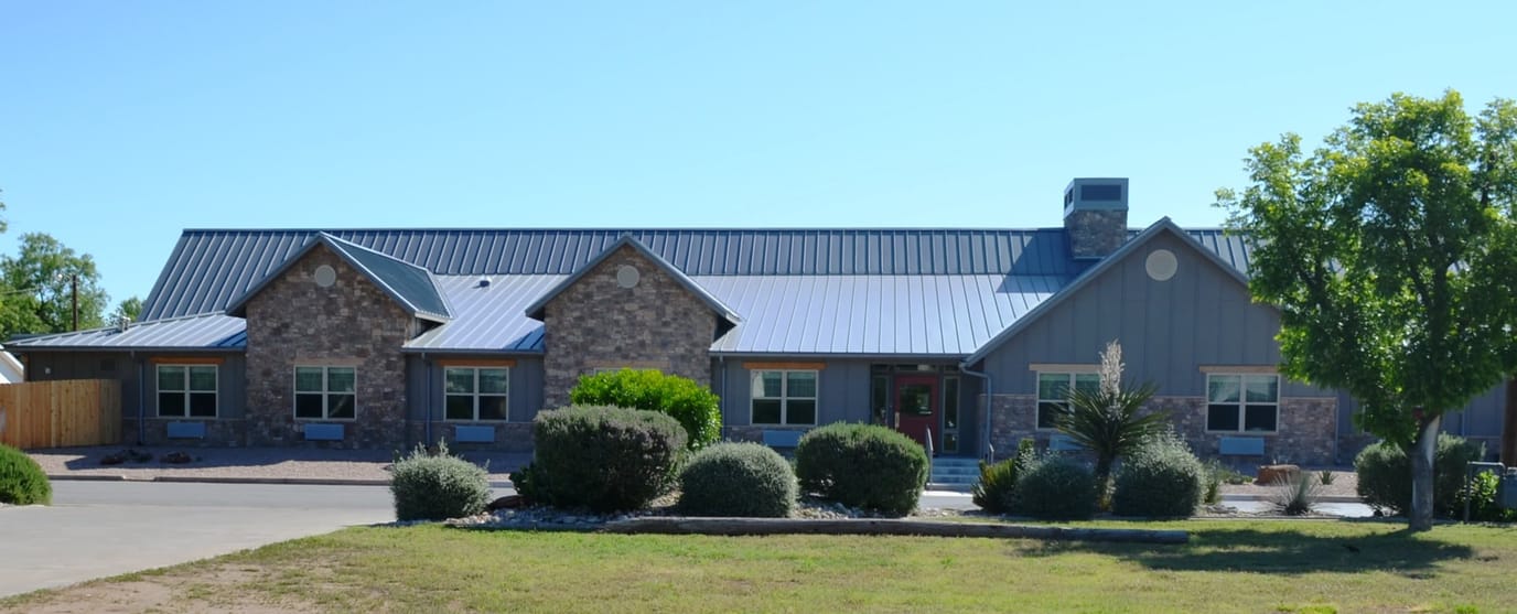 Exterior view of a senior living facility with landscaping