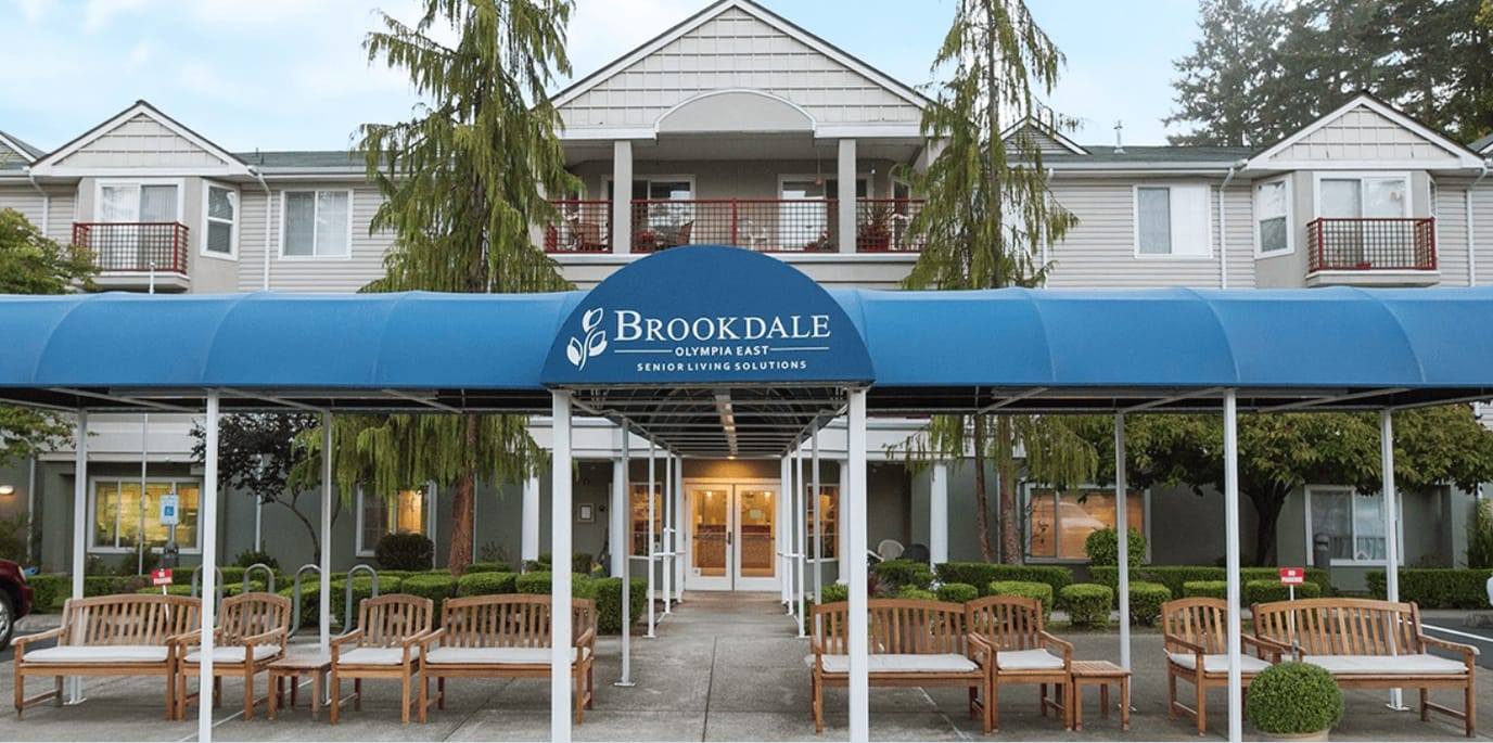 Entrance of Brookdale Olympia East with awning and seating