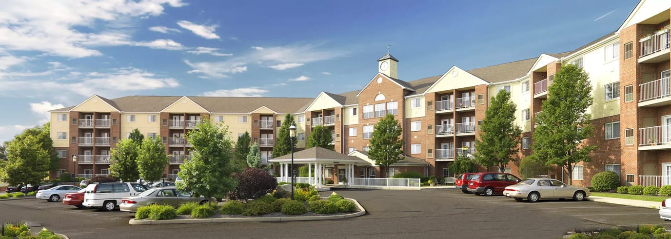 Exterior view of a senior living facility with parking