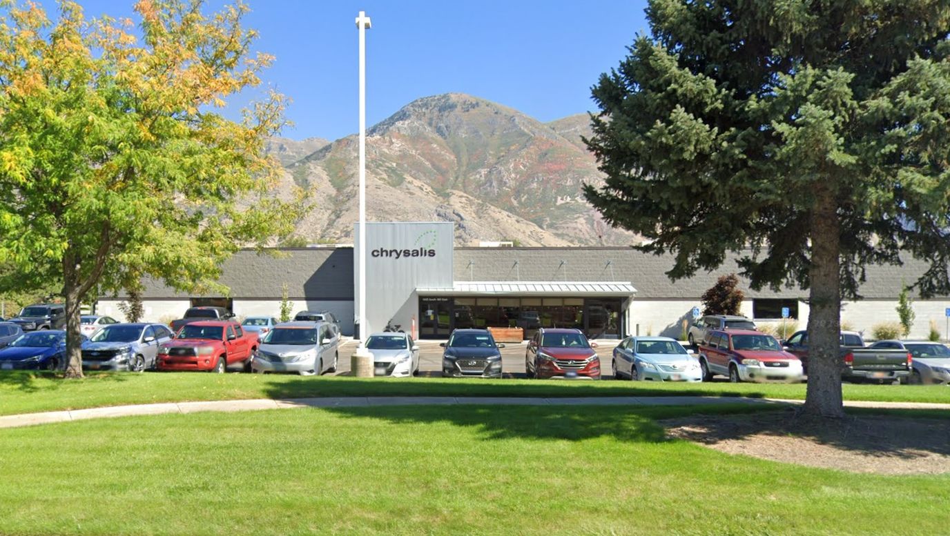 Exterior view of the Chrysalis facility with surrounding landscape