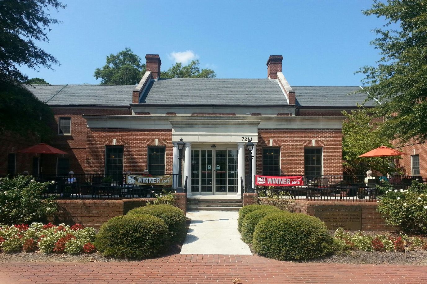 Exterior view of a senior living facility entrance with banners