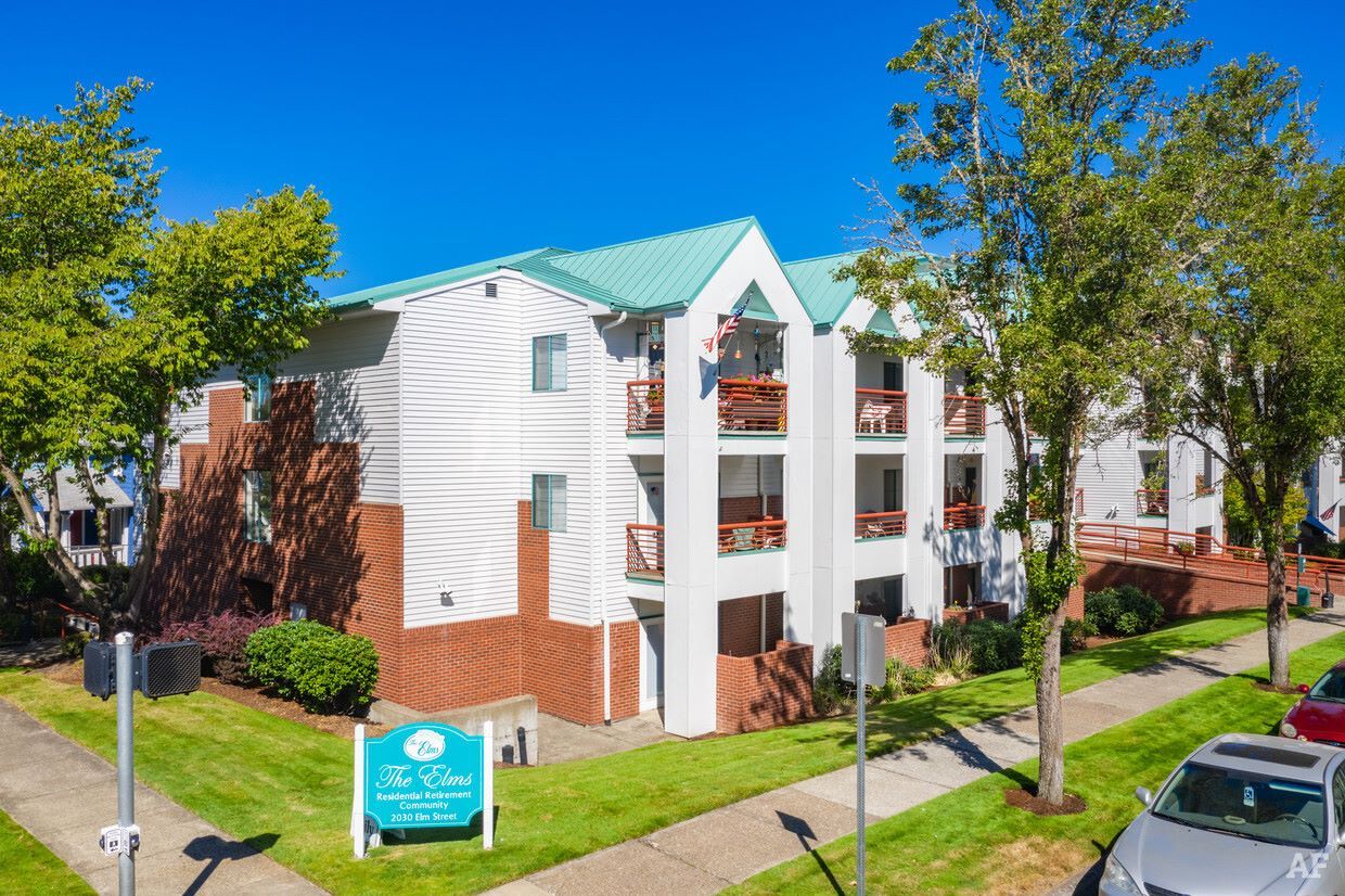 Exterior view of Elms Retirement Center with landscaping