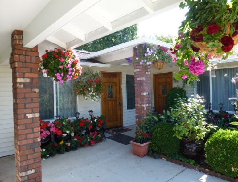 Entrance of a senior living facility with flowers