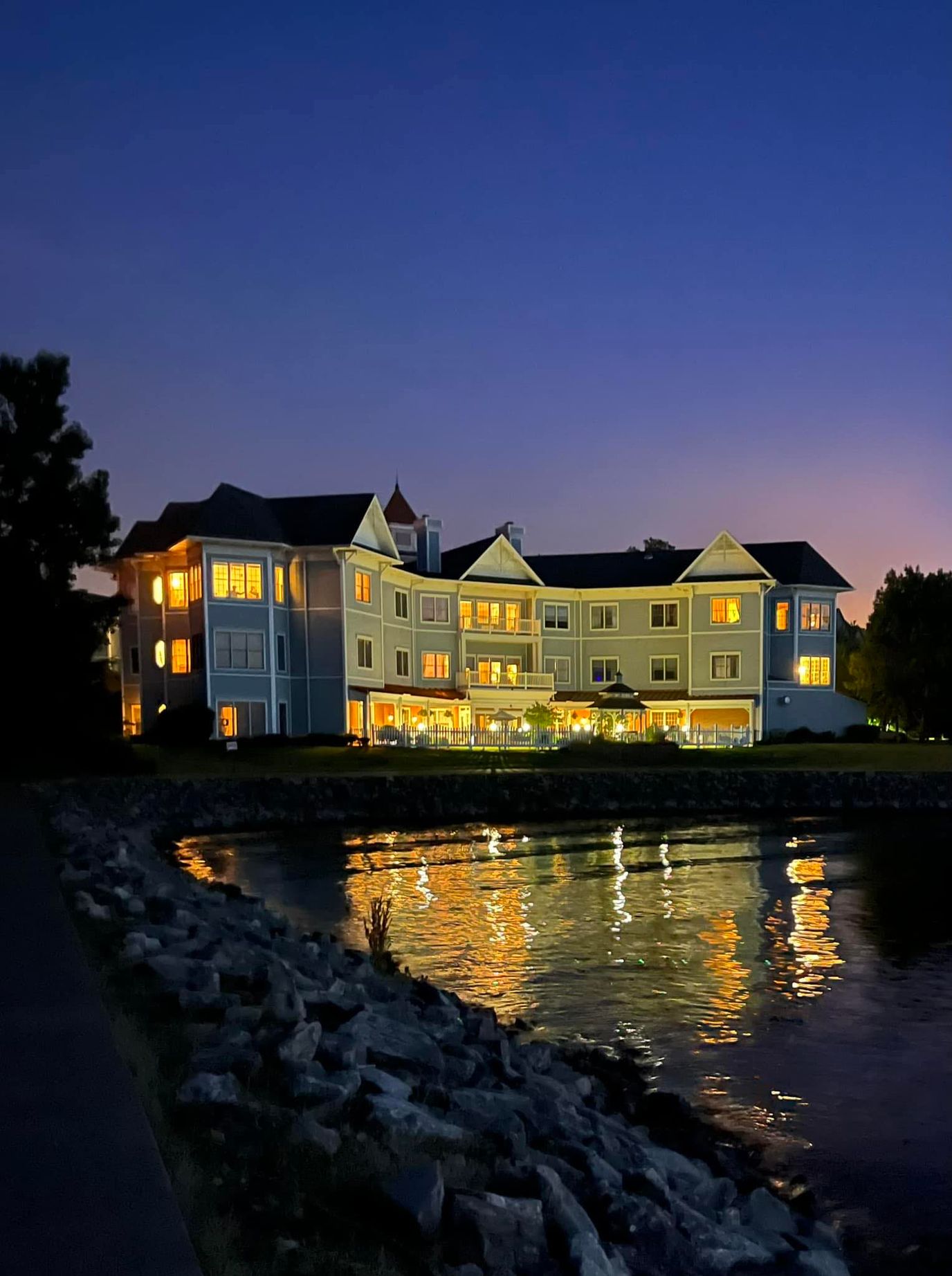 Exterior view of the facility at twilight by the water